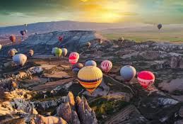 cappadocia balloons flying at sunset