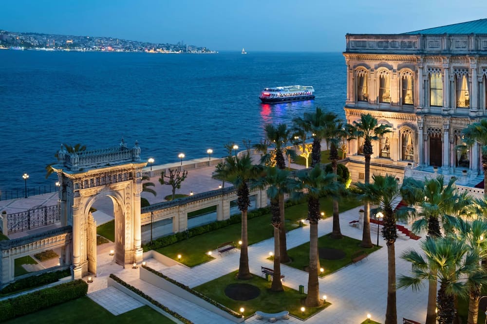 Evening view of Çırağan Palace Kempinski by the Bosphorus in Istanbul, a luxury hotel option for fans attending the 2026 UEFA Europa League Final