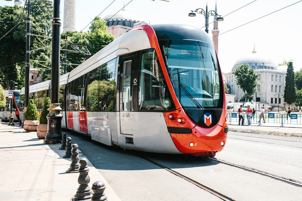 Modern Istanbul tram passing through the old city near Hagia Sophia, an easy way for fans to reach the UEFA Europa League Final venue in 2026