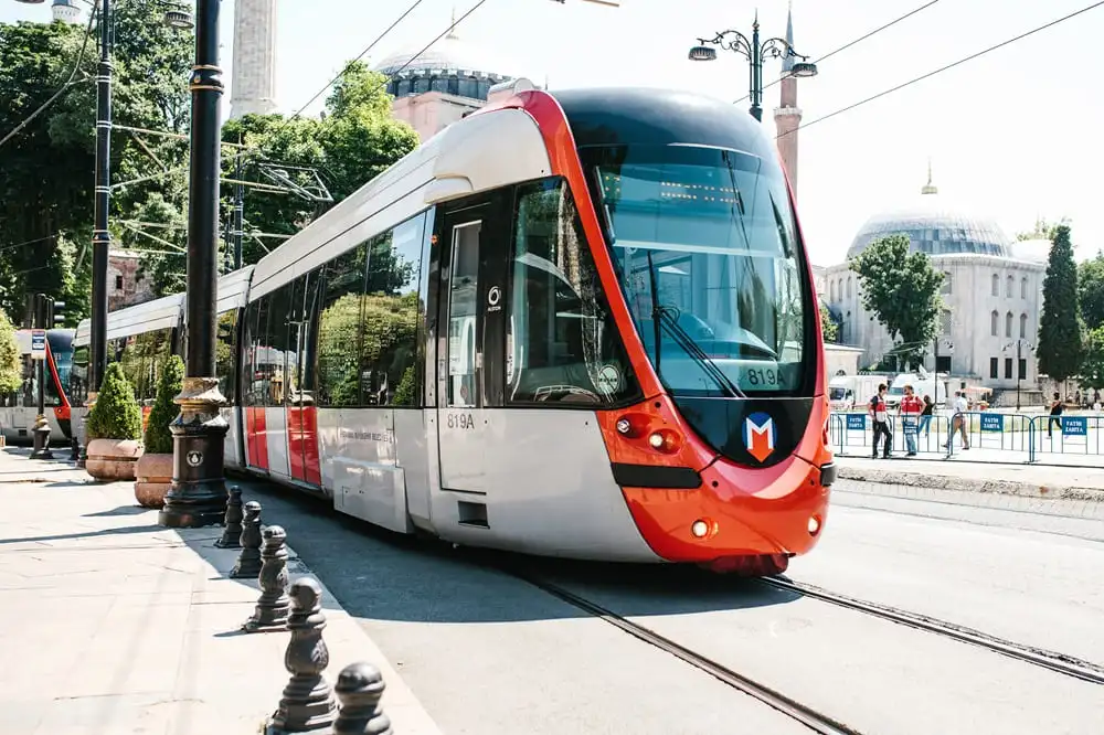 Modern Istanbul tram passing through the old city near Hagia Sophia, an easy way for fans to reach the UEFA Europa League Final venue in 2026