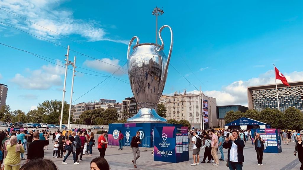 Fans gathering at Taksim Square in Istanbul with a giant UEFA Champions League trophy installation during final events