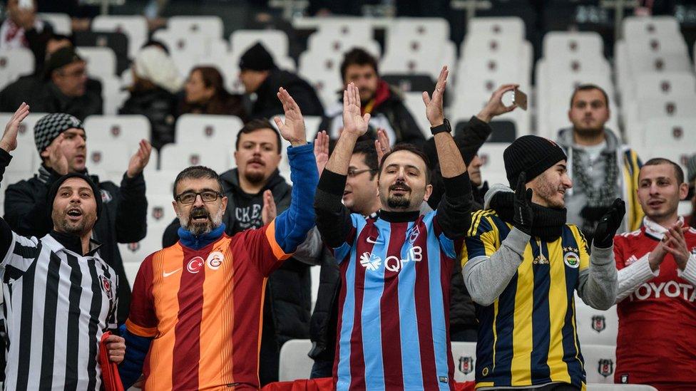 Turkish football fans wearing jerseys of Beşiktaş, Galatasaray, Trabzonspor, and Fenerbahçe showing support in Istanbul ahead of the 2026 UEFA Europa League Final
