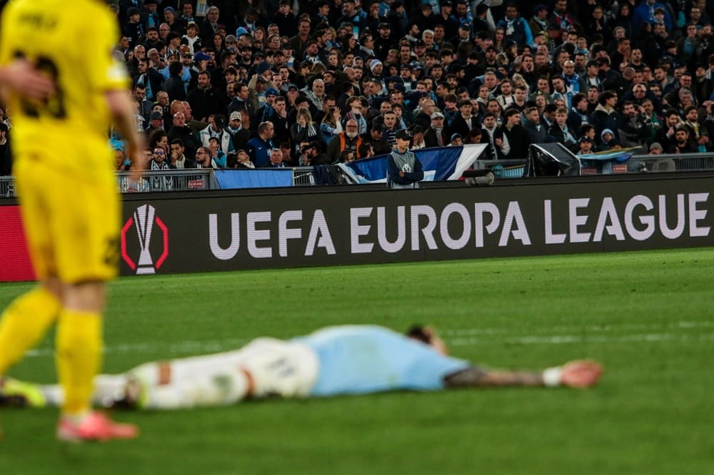 UEFA Europa League match scene with players on the pitch and passionate fans in the stands, highlighting the atmosphere leading up to the 2026 final in Istanbul