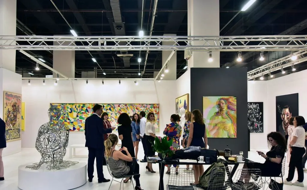 contemporary art fair istanbul exhibition Visitors inside a contemporary art fair exhibition in Istanbul